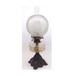 A Victorian Oil Lamp with clear glass chimney, frosted glass shade, clear glass font, raised on a