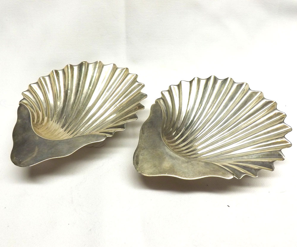 A pair of Edwardian Silver Butter Shells of typical form, supported on three ball feet, London