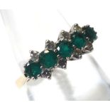 A hallmarked 18ct Gold Ring, set with five small Emeralds interspersed by eight small Brilliant
