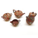 A Wedgwood Terracotta Four Piece Tea Set, polychrome decorated with floral sprigs and sprays