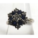 A high grade precious metal ring set with six small dark blue Sapphires and seven small Brilliant