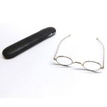 A Vintage Leather Cased Pair of Gents Gold Plated Spectacles with oval lenses, the case inscribed “