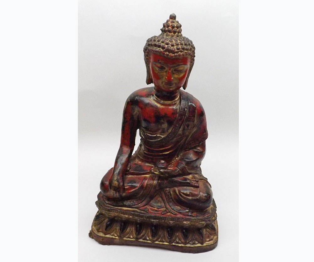 An Oriental Cast Metal Model of a Seated Buddha, decorated in red and gilded lacquer, 15” high