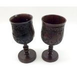 A pair of Carved Hardwood Goblets of typical form, the bowls carved with elephants and other