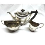 A late 19th/early 20th Century Matched Three Piece Silver Bachelors Tea Service, of half-fluted oval