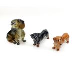 A Mixed Lot comprising: two Royal Doulton Model Dachshunds; together with a further Continental