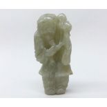 A Chinese Celadon Jade carving of an Old Man clutching a sprig of foliage, (cracks throughout), 3”