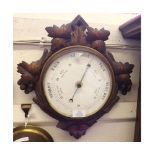 A late 19th Century Carved Oak Aneroid Barometer, the diamond-shaped case with carved fruiting