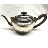 A George III Oval Silver Teapot with half-fluted decorated, treen handle and finial, London 1800, by