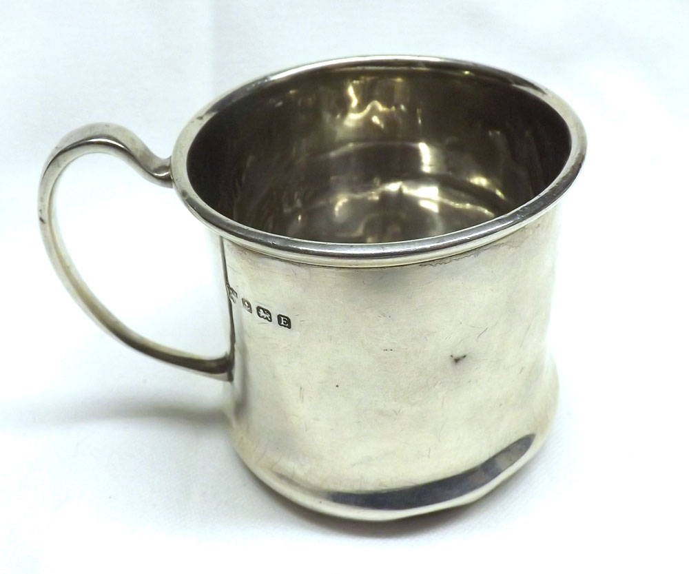 A George V small Silver Tankard of plain cylindrical form with spreading base, looped handle, (dents