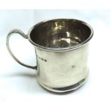 A George V small Silver Tankard of plain cylindrical form with spreading base, looped handle, (dents