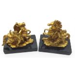 A pair of Ormolu Models of rampant horses and handlers, raised on rectangular black marble bases,