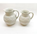 Two Copeland cream-glazed jugs decorated with geometric and ribbed detail, larges 7” high (2)