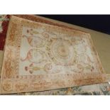 A Chinese Thick Pile Wool Rug, central floral designs within a double gull border, mainly beige/puce