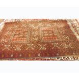 A large 20th Century Hand Knotted Caucasian Wool Rug, decorated with geometric designs on a mainly