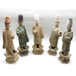 A group of five Chinese Tang style Figures, all modelled as various cloaked gents, raised on