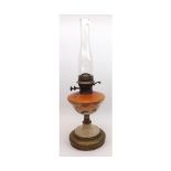 A late 19th/early 20th Century Oil Lamp with clear glass chimney, opaque floral decorated glass font