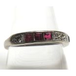 A high grade precious metal half eternity ring set with six square cut Rubies and five Brilliant Cut