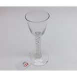 An 18th Century European Wine Glass with tapering bowl and air twist stem terminating in a spreading