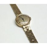 Ladies hallmarked 9ct Gold Tissot wristwatch with blued-steel hands, Gold Arabic numbers to a gilded