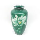 An enamelled baluster Vase decorated in colours with flowering foliage, predominately in famille