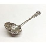 An Edwardian Silver Sifting Spoon with shell bowl and decorative handle, 5 ½” long, London 1899,