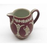 A Wedgwood small pink ground Cream Jug of baluster form, moulded pate sur pate with classical