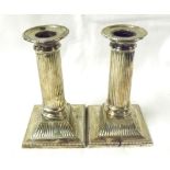 A pair of 19th or early 20th Century white metal or plated Candlesticks, formed as fluted columns on