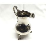 A George III Silver Cream Jug of pear shape, having card cut rim, double “C” scrolled handle and