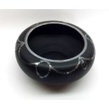 An unusual black ceramic and silver overlaid round Bowl decorated with swag type detail, no makers