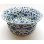 A Chinese Circular Bowl with a spreading rim, painted in underglaze blue with scrolling foliage