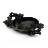 A Chinese Carved Hardwood Brush Bowl of oval form, decorated with rosettes and branches etc, 4” long