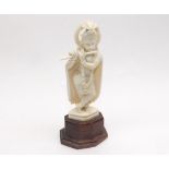 Early 20th Century Indian Ivory figure of a female Deity playing a flute, 5  high