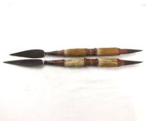 Pair of West Indian tribal short thrusting Spears, 6 =  blades, hide grips, 22 =  overall (2)