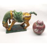 Oriental pottery model of a Tang horse, decorated predominantly in ochre and green glaze (tail