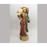 A large Royal Dux Model of a female figure carrying a double-handled Amphora vase, decorated