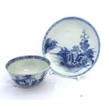 A Nankin Cargo Tea Bowl and Saucer, typically decorated in underglaze blue with Chinese river scene,