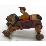 A vintage wind-up Childs Wooden Wheeled Horse and Jockey, decorated in colours, 6  long