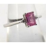 High Grade Precious Metal ring set with a rectangular pink stone to the centre, flanked to each side