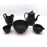 A Wedgwood Black Basalt Composite Tea Set, comprising Slop Bowl, Sugar Basin, two Jugs and a small