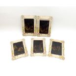 A collection of five celluloid-type coloured prints in cardboard decorative mounts depicting