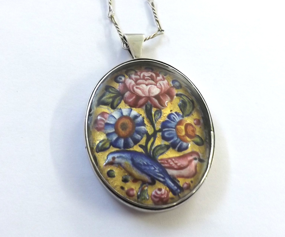 An unmarked oval white metal Pendant with embossed and enamelled oval centre in 17th Century