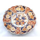 A Japanese Imari Circular Plate, with hipped rim and the centre decorated in typical colours with