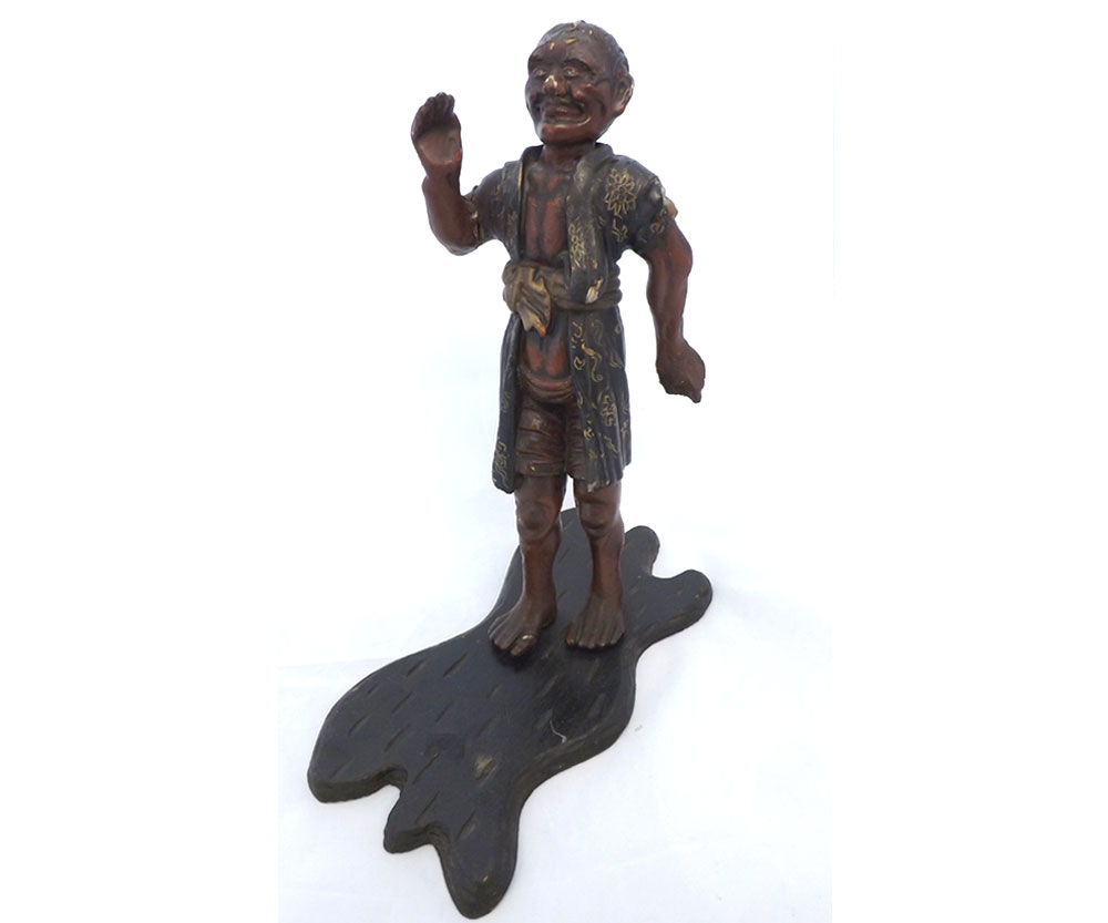 A Japanese Meiji period Carved and Lacquered Softwood Figure of a man wearing a black and gilt