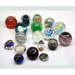 Mixed lot of various assorted 20th Century coloured glass paperweights decorated in various abstract