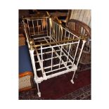 Victorian white painted Iron and Brass railed Cot, raised on short legs with castors, 50  wide