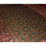 Bulgarian Kelim type carpet decorated with ochre and treacle geometric designs on a mainly green