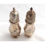 Near pair of 18th Century Silver baluster Sugar Casters with pierced pull-off lids, and plain bodies