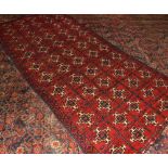 20th Century wool carpet, all over pattern of geometric cruciform designs, mainly red field with