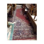 Large Caucasian style wool carpet with full gul border, central large lozenge mainly purple and blue